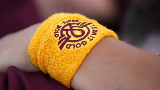 COLLEGE STATION, TX - April 13, 2024 - Turn it gold band during the game between the Vanderbilt Commodores and the Texas A&M Aggies at Blue Bell Park in College Station, TX. Photo By Julianne Shivers/Texas A&M Athletics