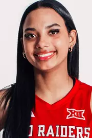 Faith Jordan in a red uniform posing for a headshot.