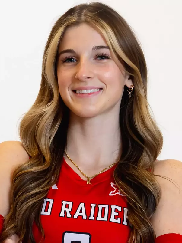 Gretchen Sigman in a red uniform posing for a headshot.