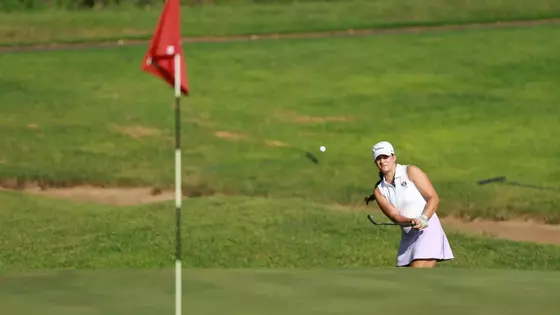 Kathryn VanArragon chips from the bunker onto the green.