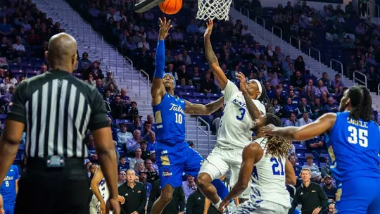 Tylen Riley shoots over a defender at Kansas State