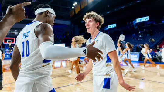 Cal Conroy and Tylen Riley celebrate Tulsa's win over Manhattan Christian