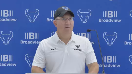 Pete Lembo speaking at a podium