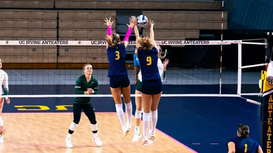 Abby Pekrul and Lois Hansen go up for a double block in an NCAA women's volleyball match against Sac State.