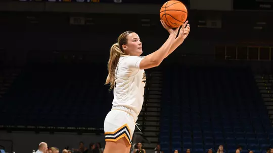 Lauryn Madsen shoots the ball during an NCAA women's basketball game.