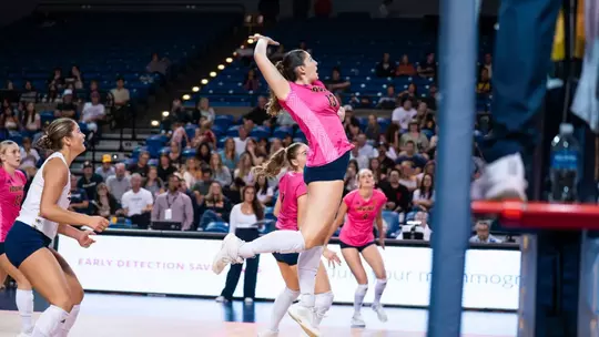 Vani Tatoulian goes up for a middle attack in an NCAA women's volleyball match.