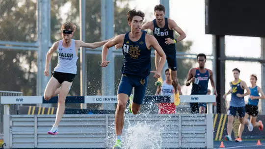 Joshua Schuld running out of the water pit in the steeplechase