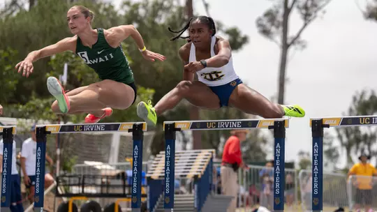 Jazzmine Davis jumps over a hurdle