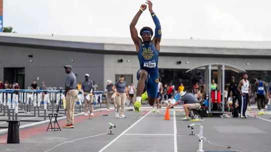 Kenechukwu Okonkwo in mid-air during a triple jump attempt