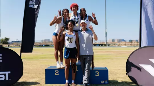Heptathletes Jolie Robinson, Joy Anderson, Jazzmine Davis, Zharia Taylor and coach Jeff Perkins pose for a photo on the podium at the Big West Championships
