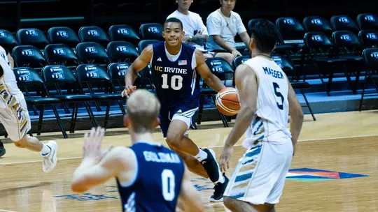 Josiah Johnson drives into the frontcourt in a 2026 William Jones Cup game vs. Malaysia