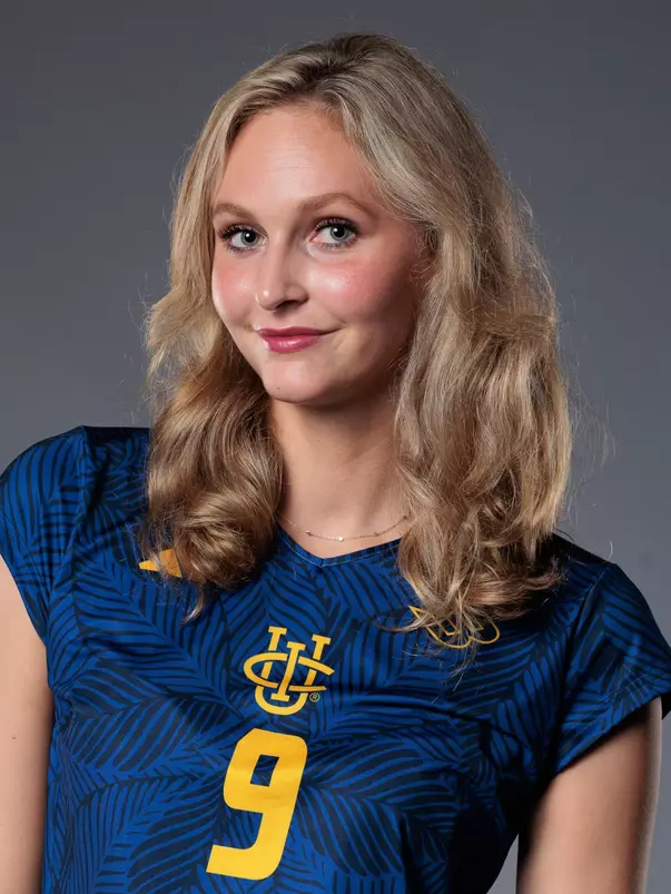 Head shot of Lois Hansen wearing a blue uniform with yellow UCI stack logo and number 9.