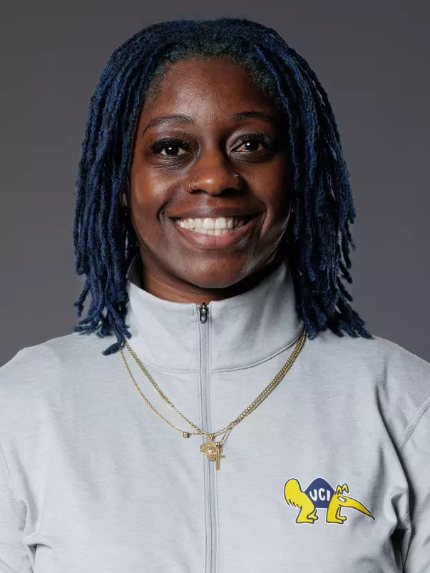 Head shot of Zykera Rice in a light gray quarter zip with the BC Anteater logo.