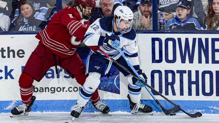 Owen Fowler battles for a puck against Colgate.