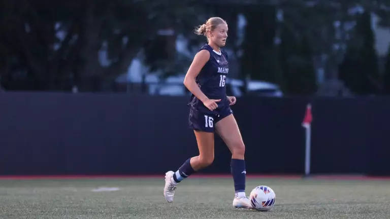 Olivia Grisdale dribbles the ball.