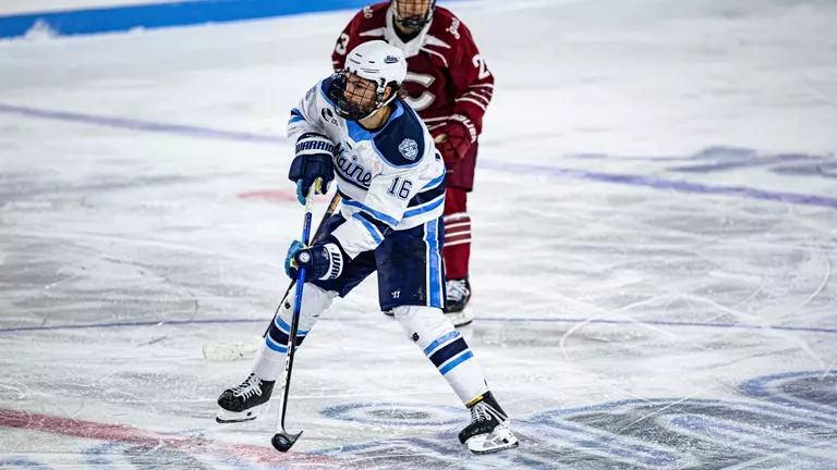 Loic Usereau with the puck in the neutral zone.