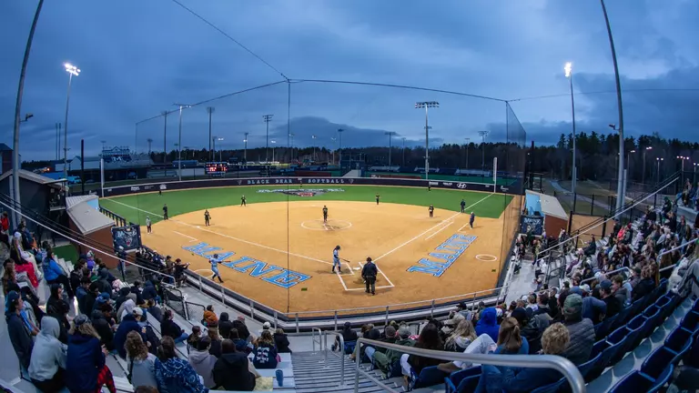 Wide shot of the Pierre & Catherine Labat Softball Complex during a night game.