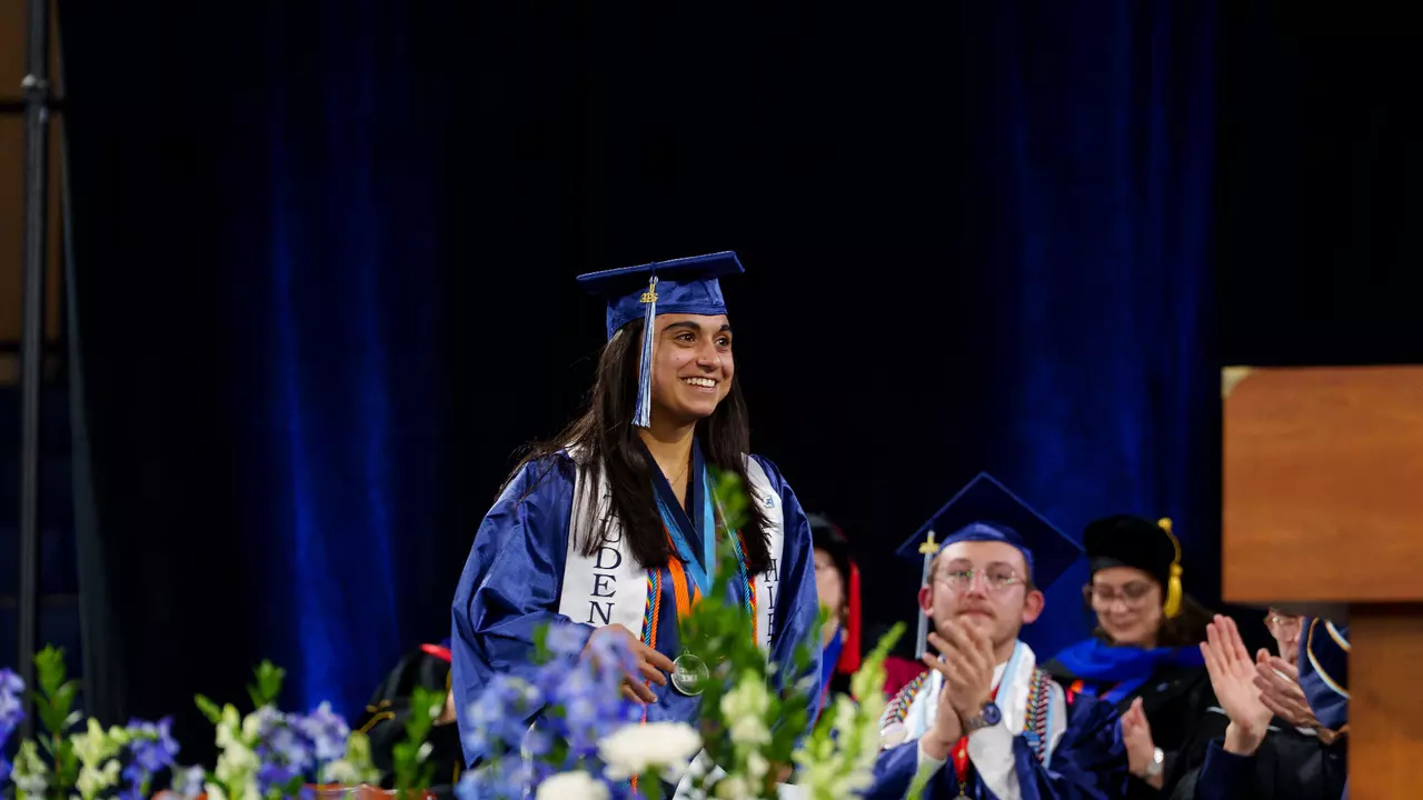 Salutatorian Isabelle Irani walks across the stage at commencement.