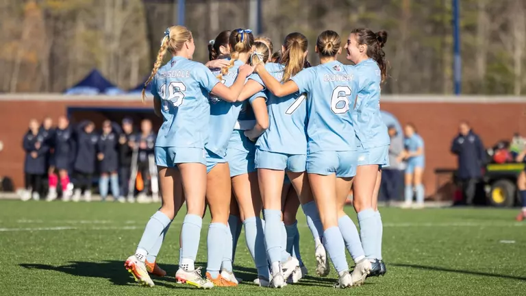Maine women's soccer celebrates a goal.