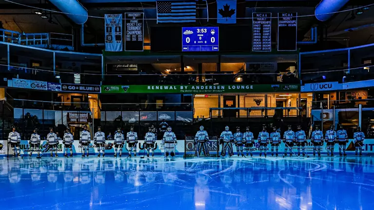 Maine women's hockey stands on the goal line pregame.