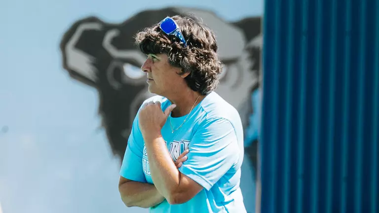 Josette Babineau is posed coaching on the sidelines of a field hockey game.