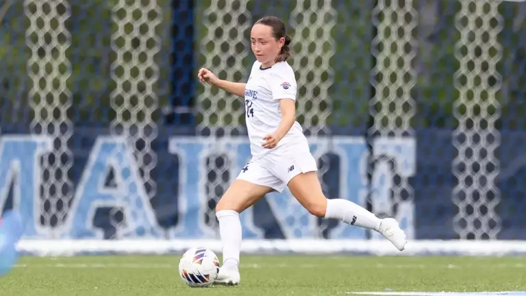 Grace Johnson kicks the ball up the field.