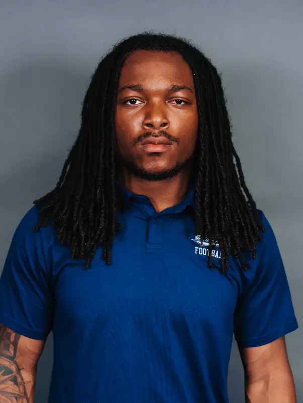 2026 Maine football roster head shot. Blue polo with Maine script.
