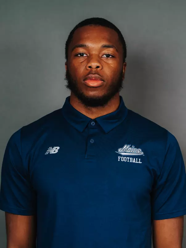 2026 Maine football roster head shot. Blue polo with Maine script.