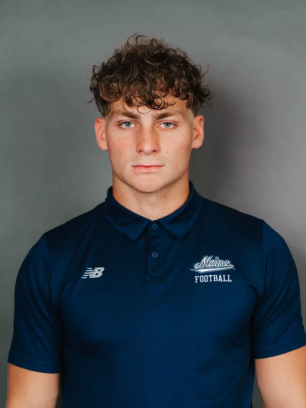 2026 Maine football roster head shot. Blue polo with Maine script.