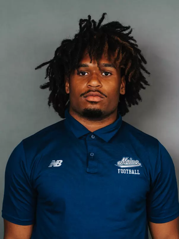 2026 Maine football roster head shot. Blue polo with Maine script.