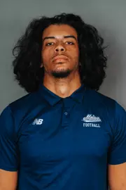 2026 Maine football roster head shot. Blue polo with Maine script.