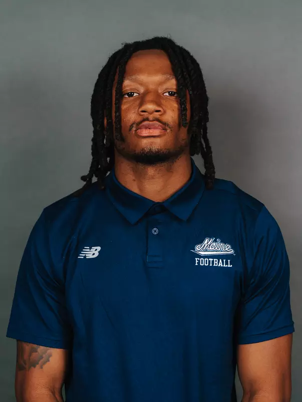 2026 Maine football roster head shot. Blue polo with Maine script.