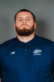 2026 Maine football roster head shot. Blue polo with Maine script.