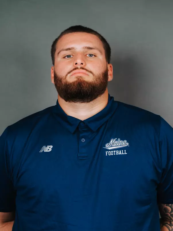 2026 Maine football roster head shot. Blue polo with Maine script.