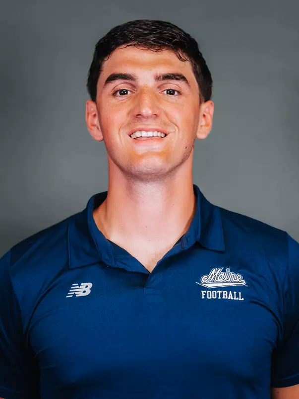 2026 Maine football roster head shot. Blue polo with Maine script.