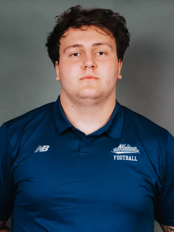 2026 Maine football roster head shot. Blue polo with Maine script.