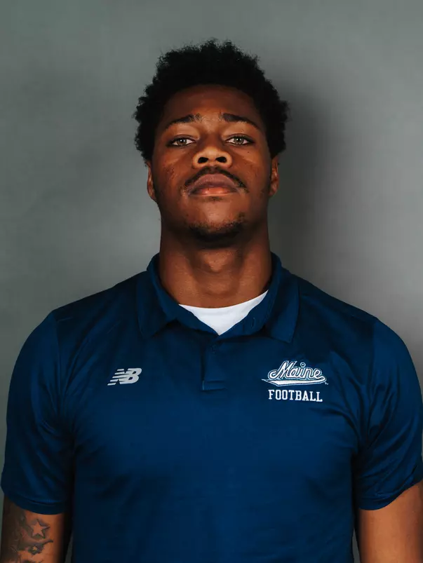 2026 Maine football roster head shot. Blue polo with Maine script.