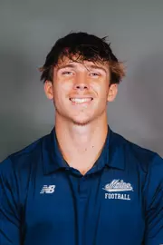 2026 Maine football roster head shot. Blue polo with Maine script.