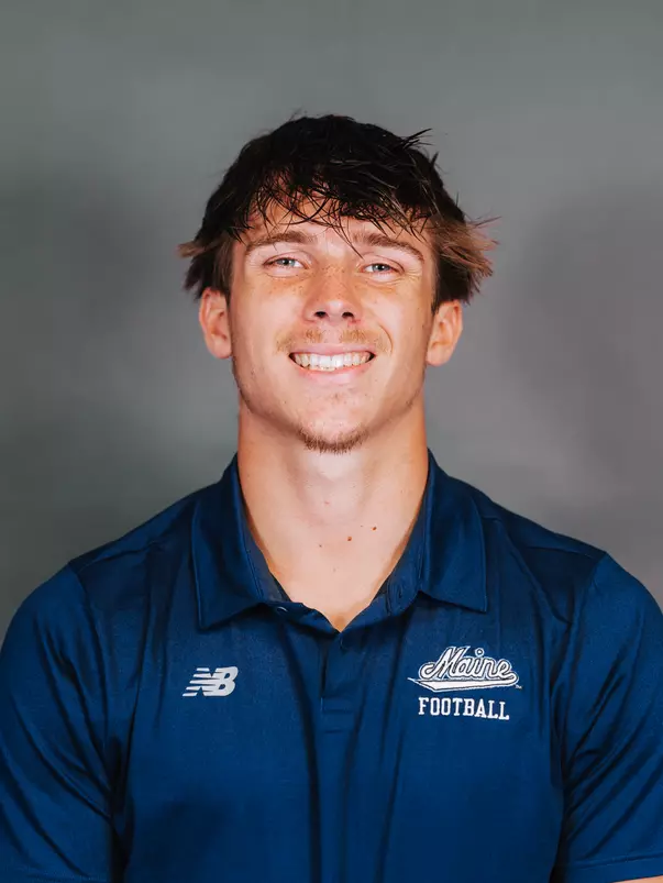 2026 Maine football roster head shot. Blue polo with Maine script.