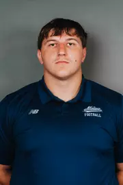 2026 Maine football roster head shot. Blue polo with Maine script.