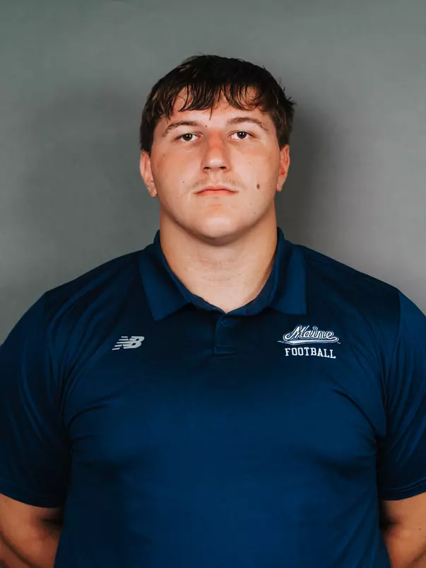 2026 Maine football roster head shot. Blue polo with Maine script.