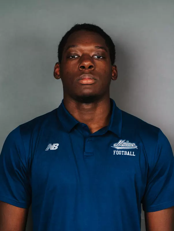2026 Maine football roster head shot. Blue polo with Maine script.