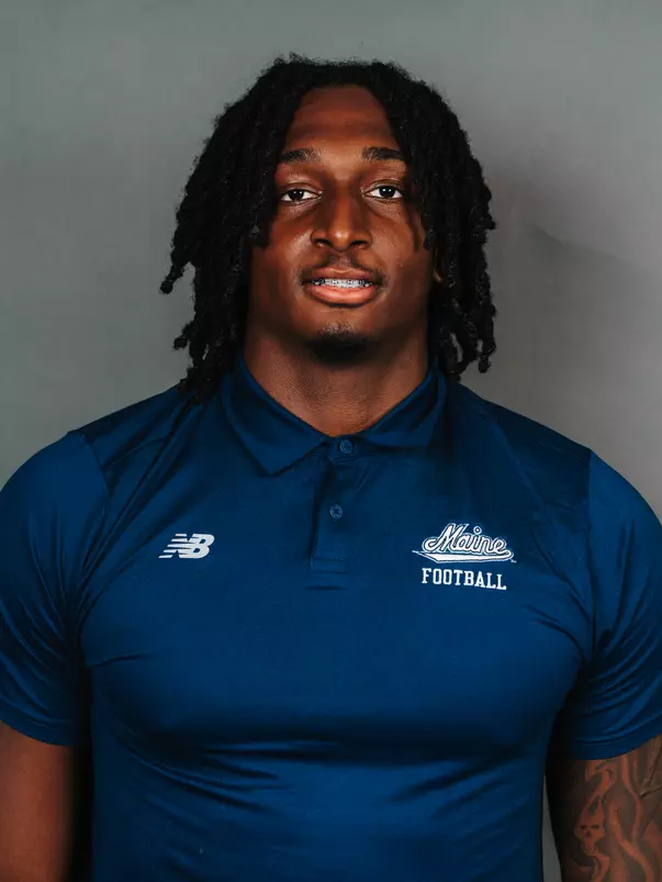 2026 Maine football roster head shot. Blue polo with Maine script.