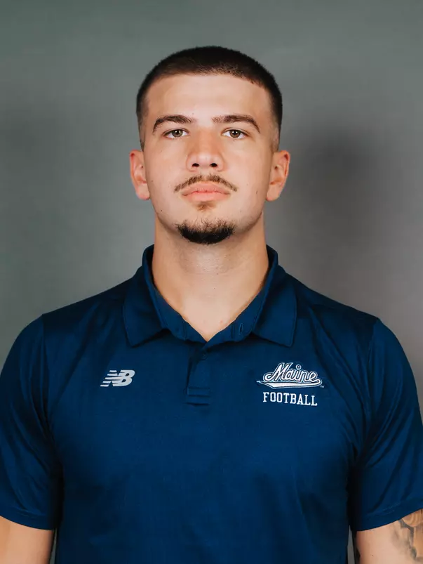 2026 Maine football roster head shot. Blue polo with Maine script.