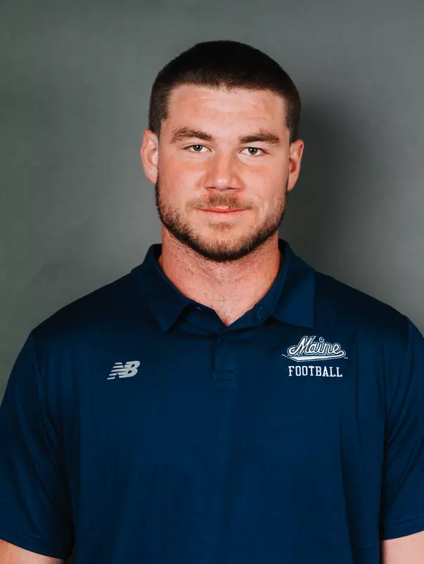 2026 Maine football roster head shot. Blue polo with Maine script.