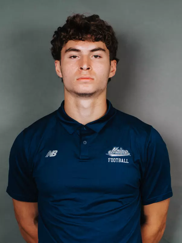 2026 Maine football roster head shot. Blue polo with Maine script.