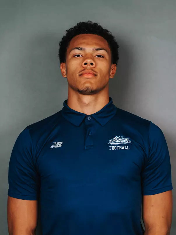 2026 Maine football roster head shot. Blue polo with Maine script.