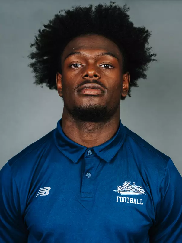 2026 Maine football roster head shot. Blue polo with Maine script.