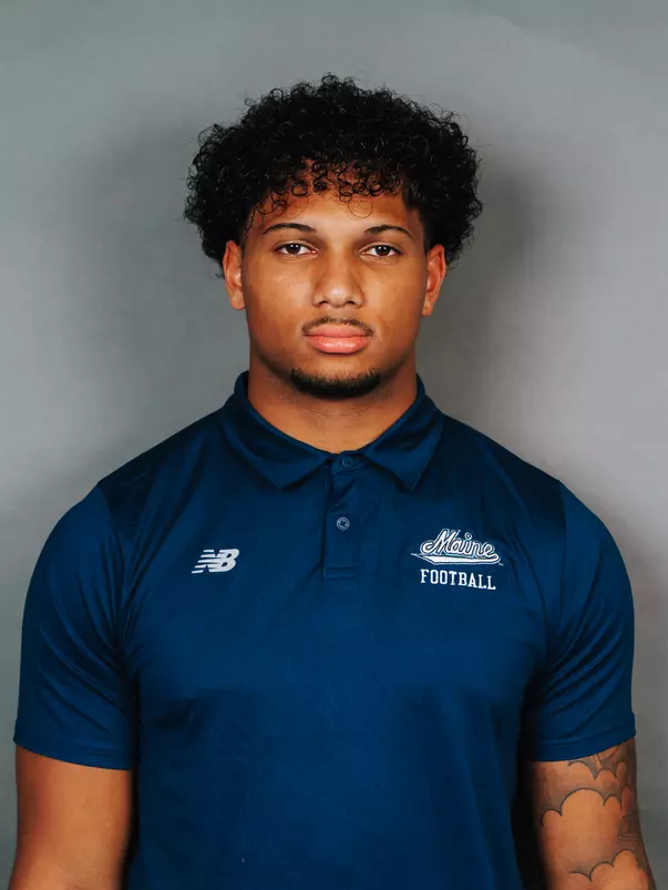2026 Maine football roster head shot. Blue polo with Maine script.