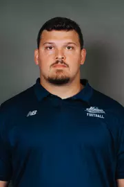 2026 Maine football roster head shot. Blue polo with Maine script.